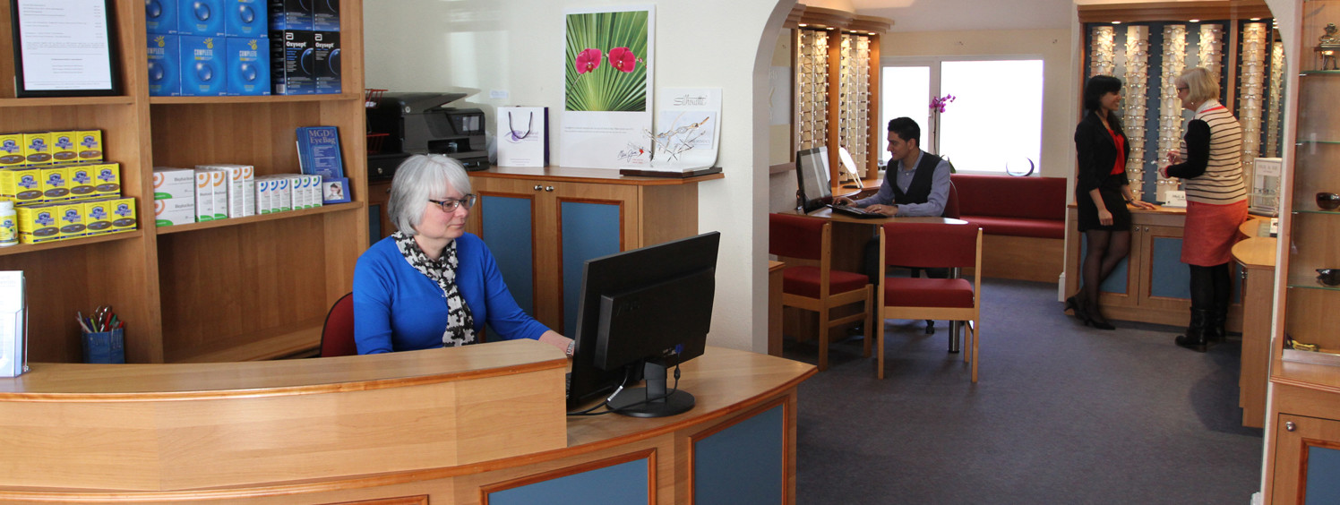 The dispensing floor at McAusland Optometrists, 3 Victoria Road Exmouth, with the frame wall visible behind two consulting tables